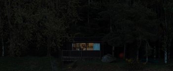 Movie still from “The Mystery of Marilyn Monroe: The Unheard Tapes” (2022), directed by Emma Cooper – A cabin in the middle of the woods at night; Extreme Wide shot, High angle