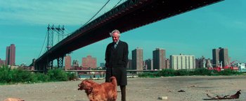 Movie still from “The New York Ripper” (1982), directed by Lucio Fulci – An old man and a dog standing in front of a bridge; Wide shot, Low angle