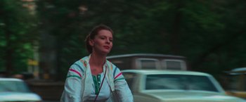 Movie still from “The New York Ripper” (1982), directed by Lucio Fulci – A woman riding a bike down a street; Close Up shot, Low angle