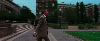 Movie still from “The New York Ripper” (1982), directed by Lucio Fulci – A man in a suit and tie walking down the street; Wide shot, Low angle