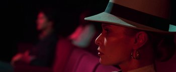 Movie still from “The New York Ripper” (1982), directed by Lucio Fulci – A woman wearing a hat sitting in a chair; Close Up shot, High angle
