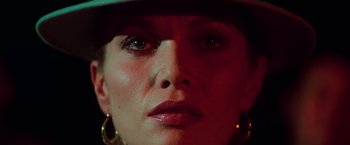 Movie still from “The New York Ripper” (1982), directed by Lucio Fulci – A woman's face with a hat on; Extreme Close Up shot, Low angle