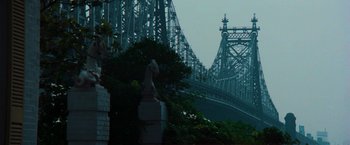 Movie still from “The New York Ripper” (1982), directed by Lucio Fulci – A view of a bridge with a statue in the foreground; Extreme Wide shot, Low angle