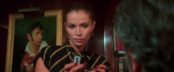 Movie still from “The New York Ripper” (1982), directed by Lucio Fulci – A woman holding a cell phone in her hands; Close Up shot, Low angle