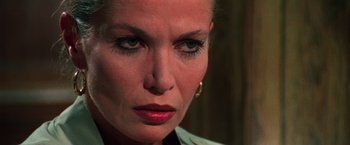 Movie still from “The New York Ripper” (1982), directed by Lucio Fulci – A woman's face with blue eyes; Close Up shot, Over the shoulder angle