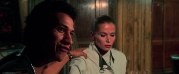 Movie still from “The New York Ripper” (1982), directed by Lucio Fulci – A man and a woman are posing for a picture; Close Up shot, Low angle