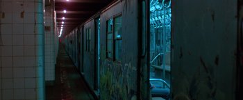 Movie still from “The New York Ripper” (1982), directed by Lucio Fulci – A subway car with graffiti on the side of it; Wide shot, High angle