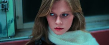 Movie still from “The New York Ripper” (1982), directed by Lucio Fulci – A person wearing a white scarf; Extreme Close Up shot, Low angle