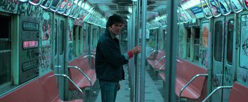 Movie still from “The New York Ripper” (1982), directed by Lucio Fulci – A man standing on a train looking at the camera; Medium shot, Low angle