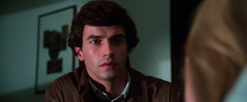Movie still from “The New York Ripper” (1982), directed by Lucio Fulci – A person wearing a brown leather jacket; Close Up shot, Low angle
