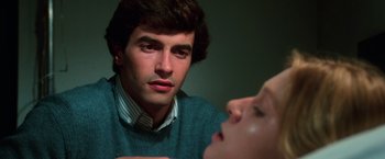 Movie still from “The New York Ripper” (1982), directed by Lucio Fulci – A man and a woman looking at one another; Close Up shot, Over the shoulder angle