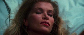 Movie still from “The New York Ripper” (1982), directed by Lucio Fulci – A person with her eyes closed; Close Up shot, Low angle