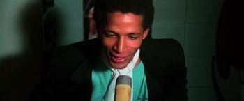 Movie still from “The New York Ripper” (1982), directed by Lucio Fulci – A man wearing a green shirt and a tie; Close Up shot, Low angle