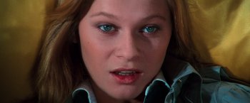 Movie still from “The New York Ripper” (1982), directed by Lucio Fulci – A woman's face with blue eyes; Close Up shot, High angle