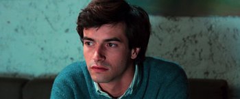 Movie still from “The New York Ripper” (1982), directed by Lucio Fulci – A person wearing a blue sweater; Close Up shot, High angle