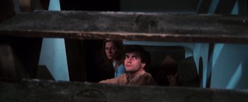 Movie still from “The New York Ripper” (1982), directed by Lucio Fulci – A man and a woman sitting next to each other; Close Up shot, High angle