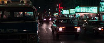 Movie still from “The New York Ripper” (1982), directed by Lucio Fulci – A city street filled with lots of traffic at night; Wide shot, Low angle