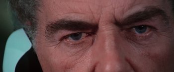 Movie still from “The New York Ripper” (1982), directed by Lucio Fulci – A man's eye with a lot of wrinkles on it; Extreme Close Up shot, Over the shoulder angle