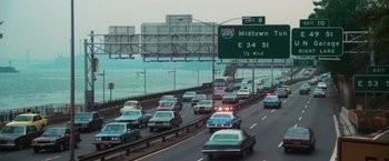 Movie still from “The New York Ripper” (1982), directed by Lucio Fulci – A busy highway with a lot of cars on it; Extreme Wide shot, High angle