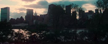 Movie still from “The New York Ripper” (1982), directed by Lucio Fulci – A view of a city skyline from across a river; Extreme Wide shot, High angle