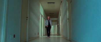 Movie still from “The New York Ripper” (1982), directed by Lucio Fulci – A woman walking down a long hallway in a building; Wide shot, Low angle