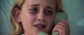 Movie still from “The New York Ripper” (1982), directed by Lucio Fulci – A young girl crying on the phone; Close Up shot, High angle
