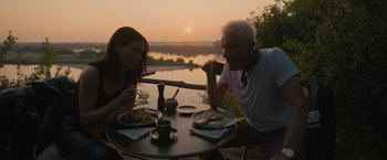A man and a woman sitting at an outdoor table