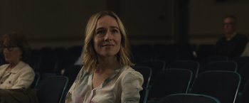 Movie still from “The Night House” (2020), directed by David Bruckner – A woman sitting in a chair in front of a projector screen; Close Up shot, Over the shoulder angle