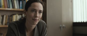 Movie still from “The Night House” (2020), directed by David Bruckner – A person sitting in front of a door; Close Up shot, Over the shoulder angle