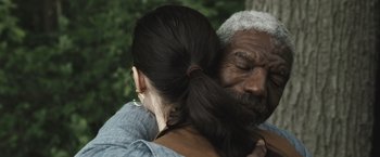 Movie still from “The Night House” (2020), directed by David Bruckner – An older man and a younger woman hugging each other; Close Up shot, Over the shoulder angle