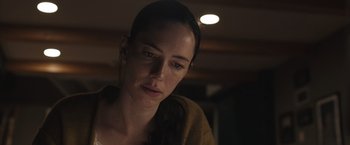 Movie still from “The Night House” (2020), directed by David Bruckner – A person looking at the camera; Close Up shot, Low angle
