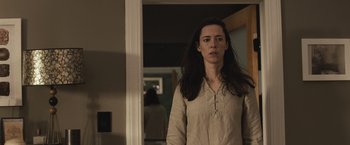 Movie still from “The Night House” (2020), directed by David Bruckner – A woman standing in front of a mirror in a room; Medium shot, Low angle