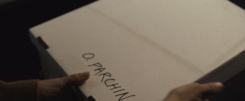 Movie still from “The Night House” (2020), directed by David Bruckner – A person writing on a piece of paper; Extreme Close Up shot, High angle