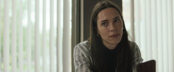 Movie still from “The Night House” (2020), directed by David Bruckner – A person sitting in front of a window; Close Up shot, Low angle