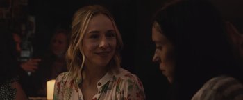 Movie still from “The Night House” (2020), directed by David Bruckner – Two women talking to each other in front of a black background; Close Up shot, Over the shoulder angle
