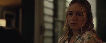 Movie still from “The Night House” (2020), directed by David Bruckner – A person wearing a green shirt; Close Up shot, Over the shoulder angle