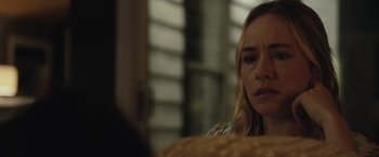 Movie still from “The Night House” (2020), directed by David Bruckner – A woman sitting at a table looking sad; Close Up shot, Over the shoulder angle