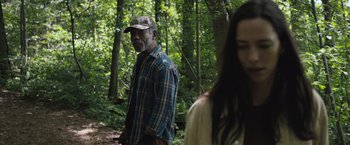 Movie still from “The Night House” (2020), directed by David Bruckner – An older man and a young woman in the woods; Medium shot, Over the shoulder angle