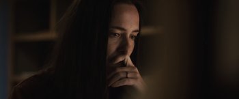 Movie still from “The Night House” (2020), directed by David Bruckner – A person with her hand to her face; Close Up shot, High angle