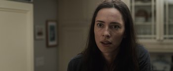 Movie still from “The Night House” (2020), directed by David Bruckner – A person with long black hair; Close Up shot, Over the shoulder angle