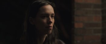 Movie still from “The Night House” (2020), directed by David Bruckner – A person with long dark hair; Close Up shot, Low angle