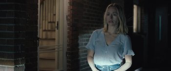 Movie still from “The Night House” (2020), directed by David Bruckner – A woman standing in front of a brick wall with her hands on her hips; Medium shot, Over the shoulder angle