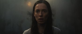 Movie still from “The Night House” (2020), directed by David Bruckner – A woman with long dark hair stares into the camera; Close Up shot, Low angle
