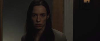 Movie still from “The Night House” (2020), directed by David Bruckner – A woman with long black hair is staring at the camera; Close Up shot, Over the shoulder angle