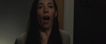Movie still from “The Night House” (2020), directed by David Bruckner – A woman with long black hair is looking at the camera; Close Up shot, Low angle