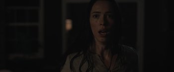 Movie still from “The Night House” (2020), directed by David Bruckner – A woman with long dark hair stares at the camera; Close Up shot, Low angle