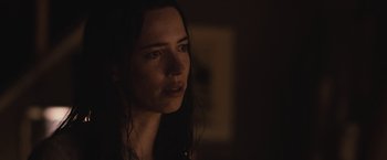 Movie still from “The Night House” (2020), directed by David Bruckner – A person in a dark room; Close Up shot, Over the shoulder angle
