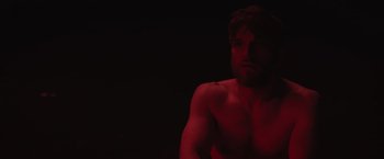 Movie still from “The Night House” (2020), directed by David Bruckner – A man with no shirt in a dark room; Close Up shot, Low angle