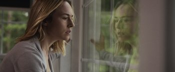 Movie still from “The Night House” (2020), directed by David Bruckner – A woman looking out of a window at another woman; Close Up shot, Over the shoulder angle