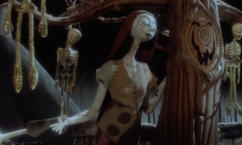 Movie still from “The Nightmare Before Christmas” (1993), directed by Henry Selick – A woman standing next to a tree with a skeleton hanging from it; Medium shot, Low angle